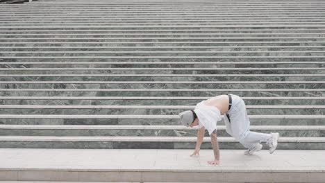 breakdancer performing various moves on urban steps