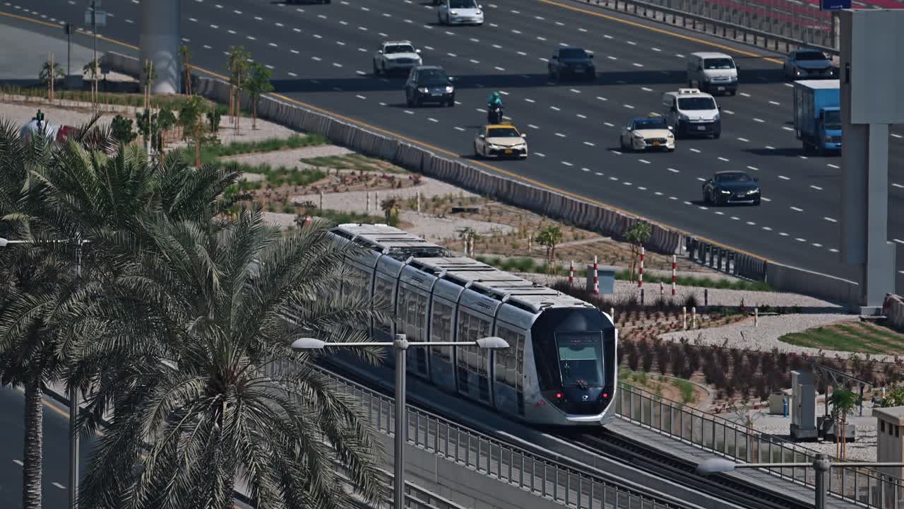 A Dubai Metro train approaches the station along Sheikh Zayed Road in Dubai, UAE.