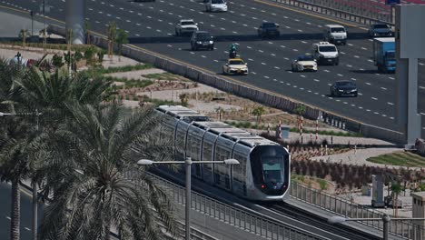 a dubai metro train approaches the station along sheikh zayed road in dubai, uae.