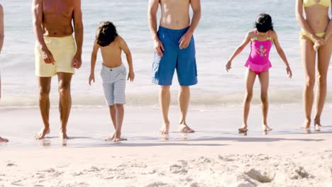 Cute-family-standing-on-the-beach