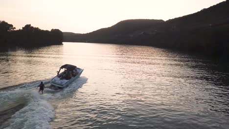 Aerial-drone-shot-of-a-boat-with-a-wakeboarder-on-the-Colorado-River