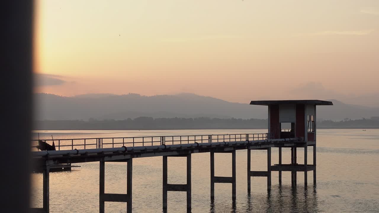 Landscape view of Bang Phra Reservoir with old pumping station at sunrise.