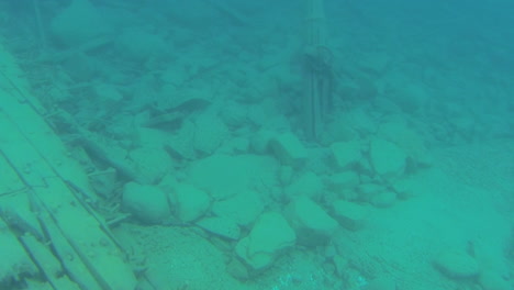 exploring a sunken ship at the bottom of a lake