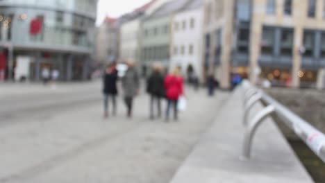 Blurry-people-moving-in-downtown-Erfurt,-historic-city-in-Germany