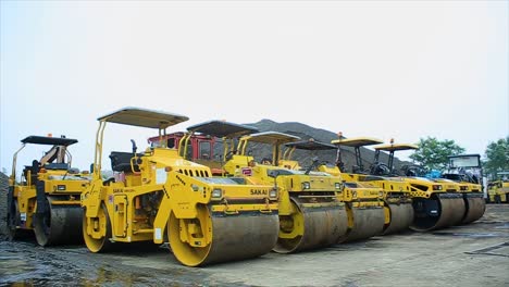 rolling machine, tandem roller, which is type of heavy compactor construction vehicle used to level soil, gravel, concrete or asphalt in road construction