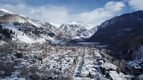 distant drone aerial view of telluride, colorado in the winter on a sunny day