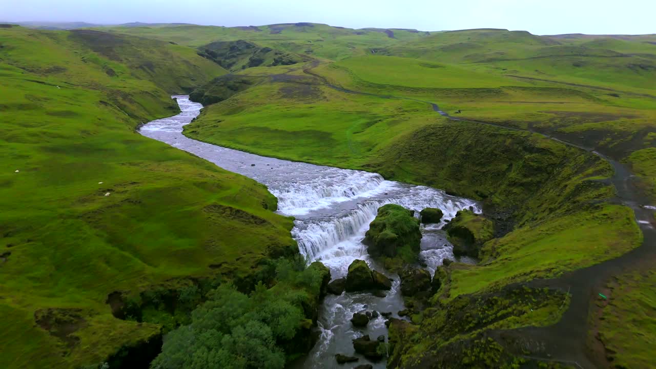 Soar above Skógafoss waterfall and admire the vibrant rainbow that often forms in the mist, highlighting the enchanting allure of Iceland’s natural wonders.