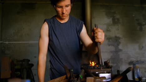 metalsmith working in workshop 4k