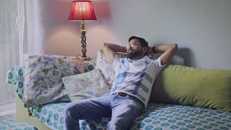 man relaxing on sofa at home
