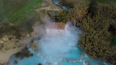 the thermal hot springs bath and waterfall at saturnia, tuscany italy close to siena and grosseto at sunrise