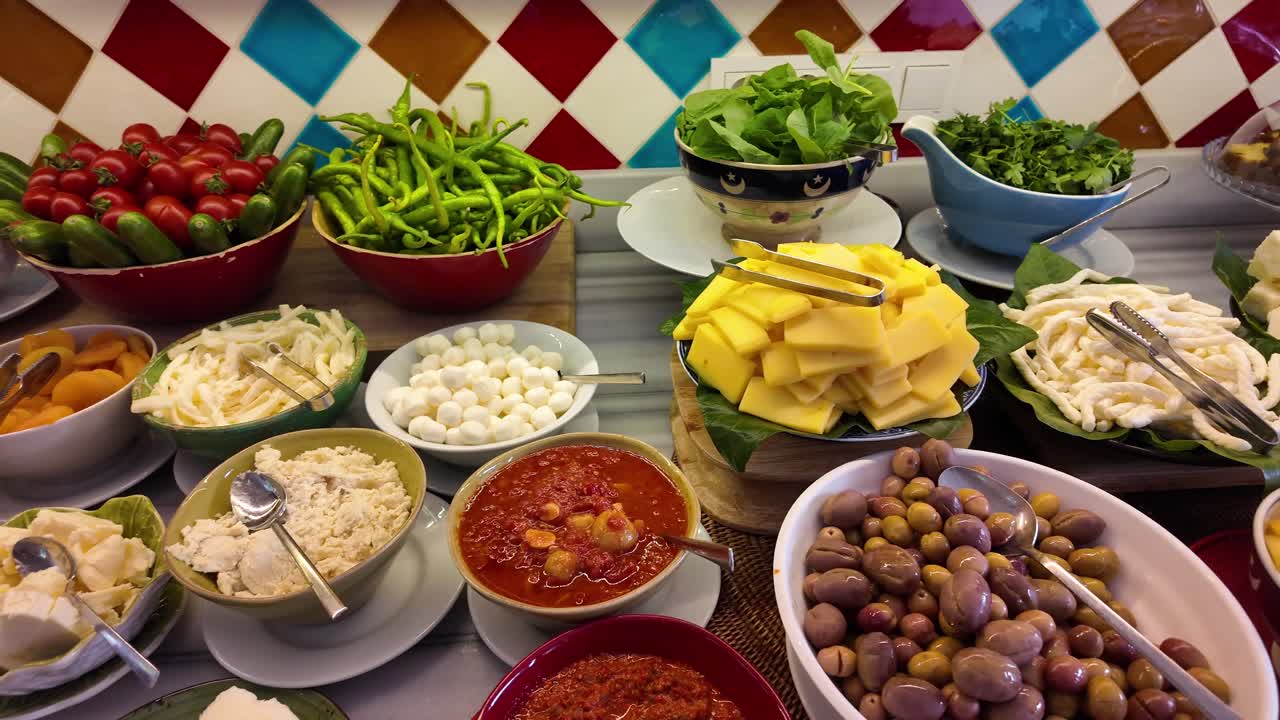 Food buffet with cheese, olives, salad and vegetables