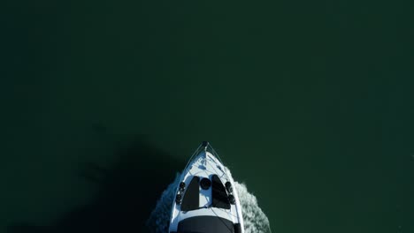 top down pass over the yacht as it rolls along the shoreline in the bay