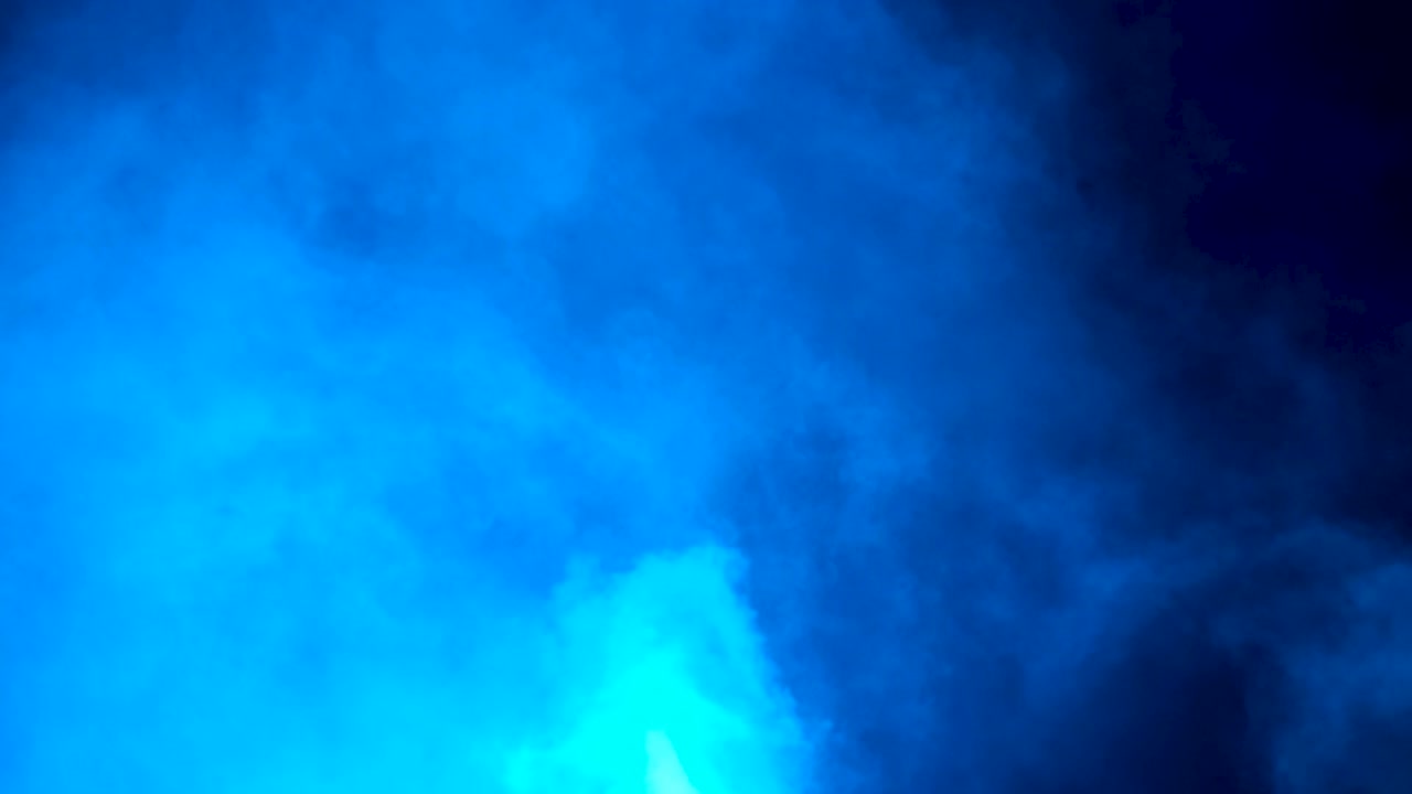 Static Shot of Mezmerizing Swirling White Smoke Backed by Blue Lights with White Strobe Flashes