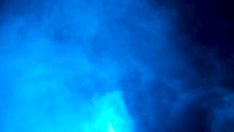 static shot of mezmerizing swirling white smoke backed by blue lights with white strobe flashes