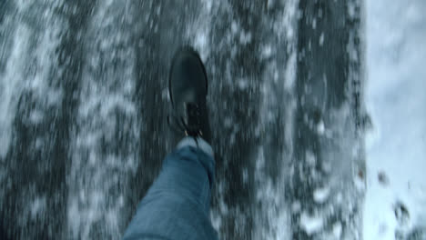 male walking a slippery froozen street pov in winter