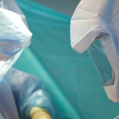 coronavirus. medical workers in protective suit work in the hospital. surgical procedure in clinic during pandemic. critical care concept.