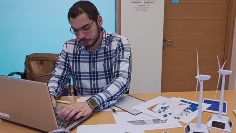 Man working on a laptop at an office desk