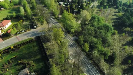 aerial view of a road going past housing estate