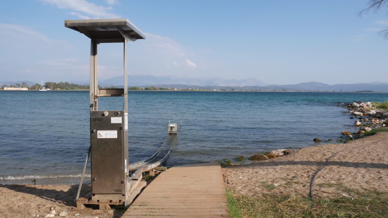 Locked shot of Equipment to help people with disabilities enter the sea, Kiani Akti beach.