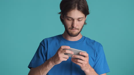 Caucasian-man-in-front-of-camera-on-blue-background.