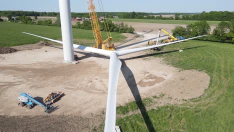 wind turbine blades ready to be lifted on top, aerial ascend view