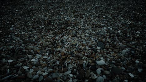 se déplaçant sur les cailloux de la plage au coucher du soleil