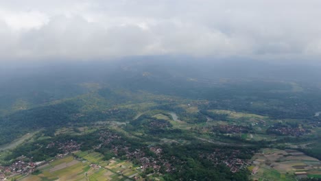 countryside life of indonesia village near foggy mountains, aerial drone view
