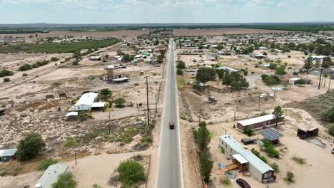 truck driving through low income housing in southwest usa desert