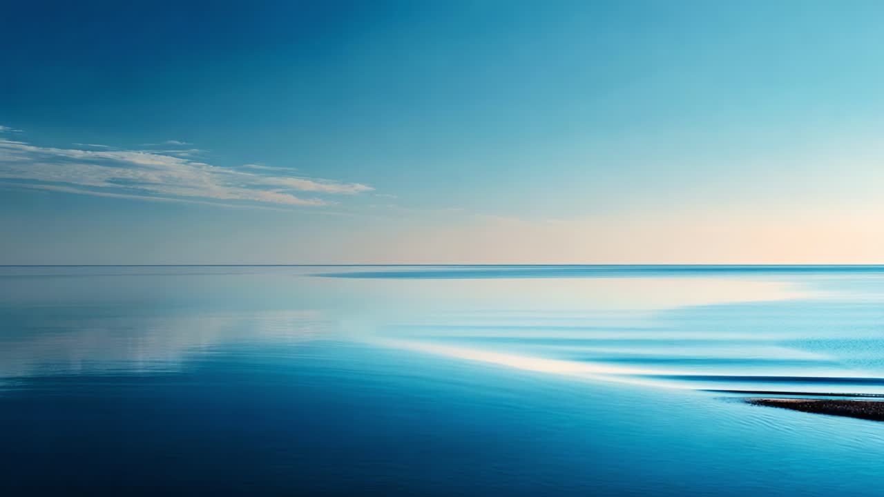 A Serene Coastal Experience: Tranquil Horizon Over Calm Water with Gentle Waves Reflecting Soft Light and a Touch of Cloud in the Clear Blue Sky