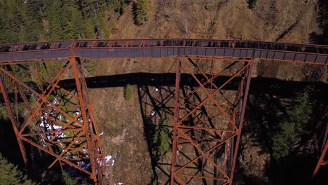 aerial drone shot panning across ladner creek trestle railway bridge in british columbia, canada