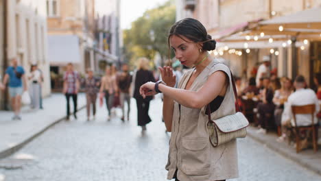 Scared-woman-worrying-to-be-punctual,-with-anxiety-checking-time-on-watch,-running-late-to-work