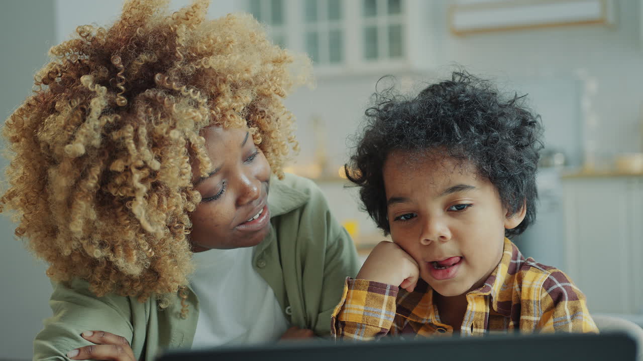 Curious Little Kid Watching Video on Laptop with Mom at Home