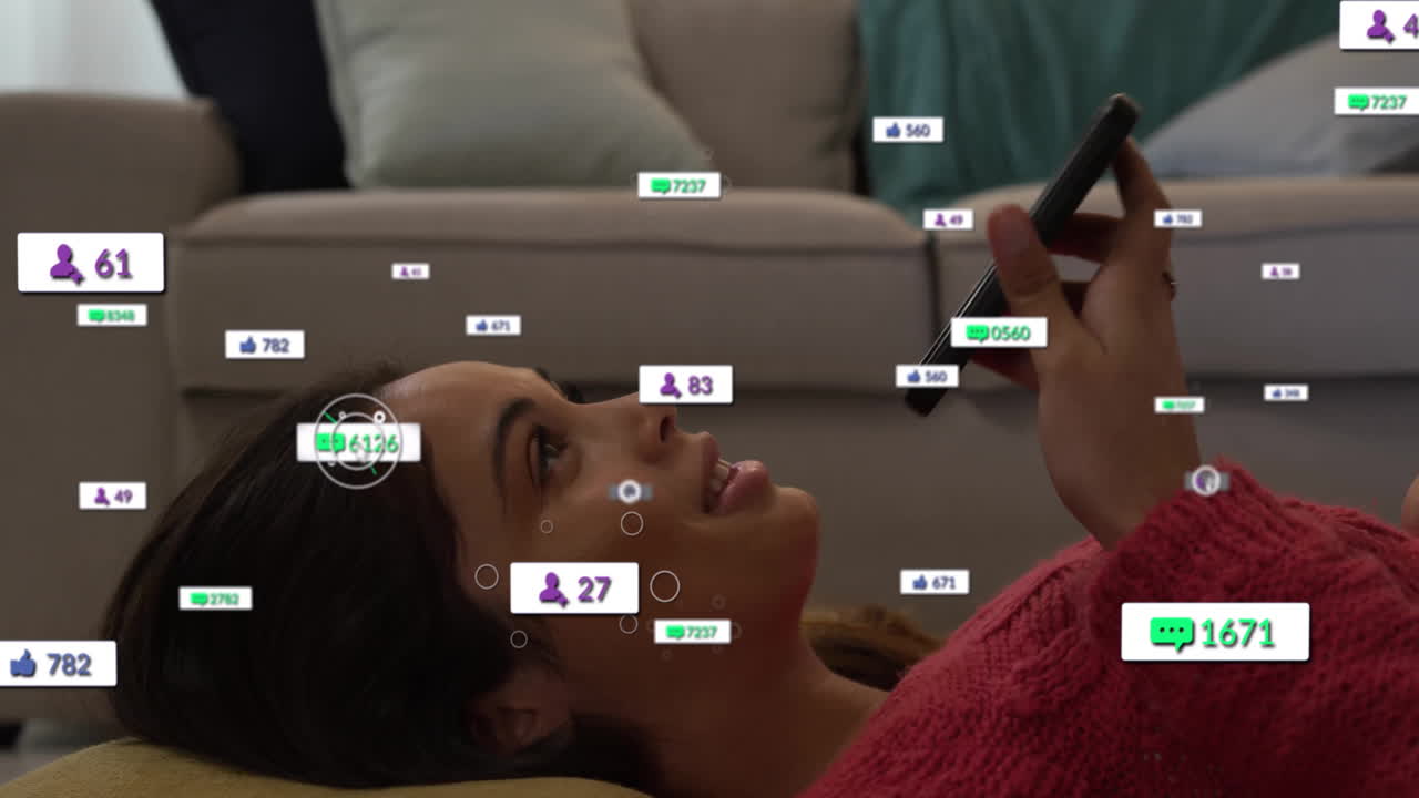 woman lying on couch scrolling phone, showing floating engagement icons for social media marketing