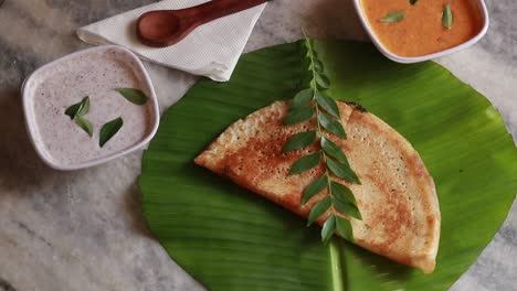 rotating masala dosa - indian savory crepes with potato filling , top down view