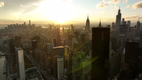 Aerial-panoramic-footage-of-cityscape-with-tall-downtown-skyscrapers.-View-against-colourful-sunset-sky.-Manhattan,-New-York-City,-USA