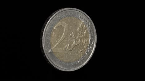 free-floating 2 euro coin with the austrian backside on black background