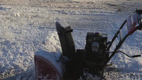 slow motion side view of snow blower