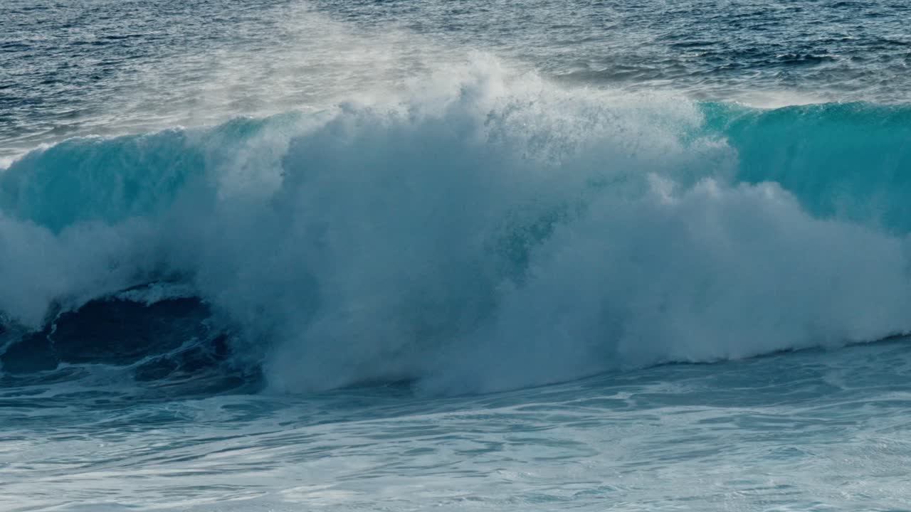Dramatic ocean waves collide with the volcanic coastline near Timanfaya National Park, located on the island of Lanzarote in the Canary Islands, Spain.