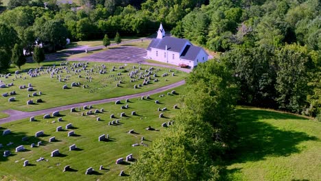 aerial-push-in-to-quaint-church-over-treetops-near-fries-virginia