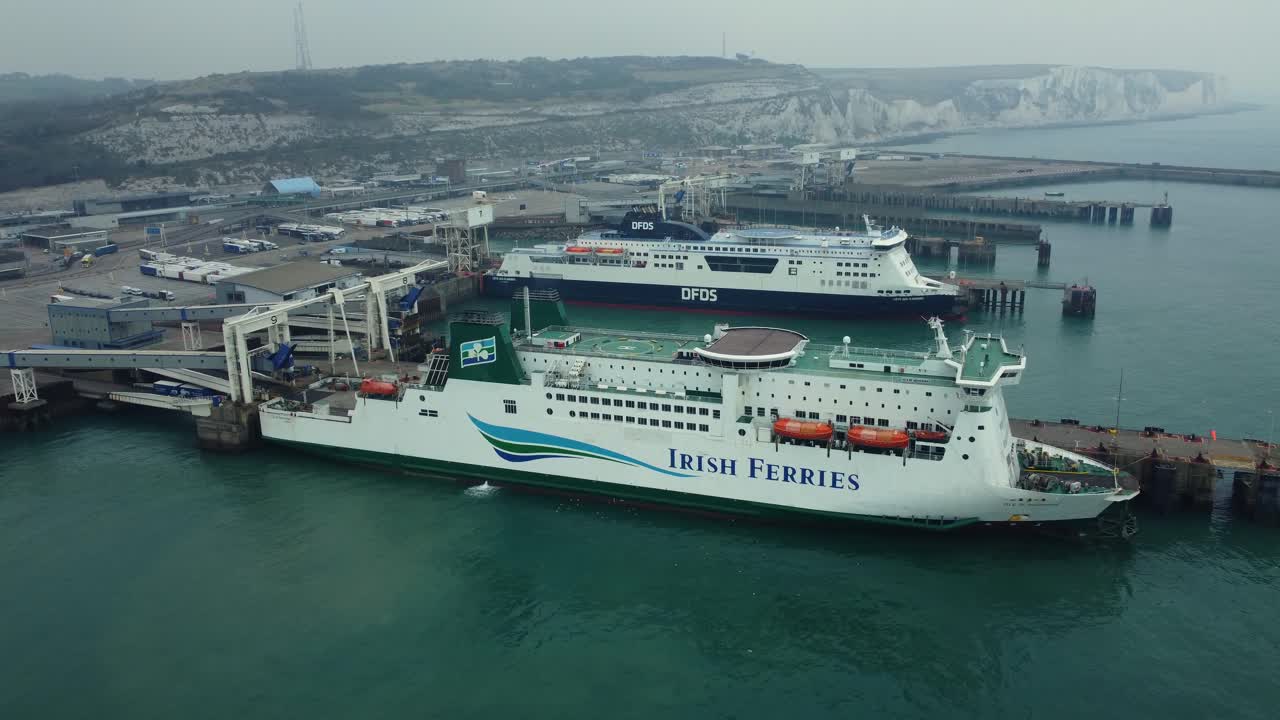 Two ferries docked in a busy port