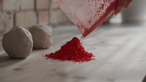 preparing clay with red pigment