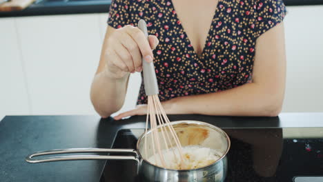 attractive housewife preparing caramel at home