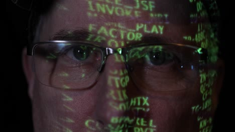 man with digital computer code projected on his face