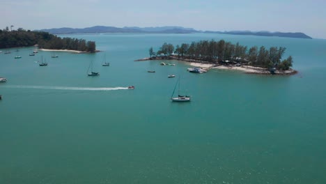 aerial footage of a speed boat among sailing boats in the sea