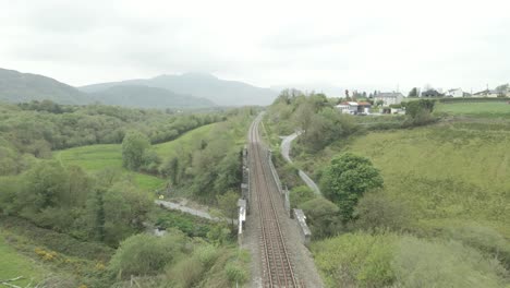 Rusty-Train-Tracks-And-Bridge-Through-Green-Valley-In-County-Kerry,-Ireland