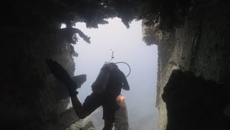 scuba diver exiting a boat wreckage in 4k