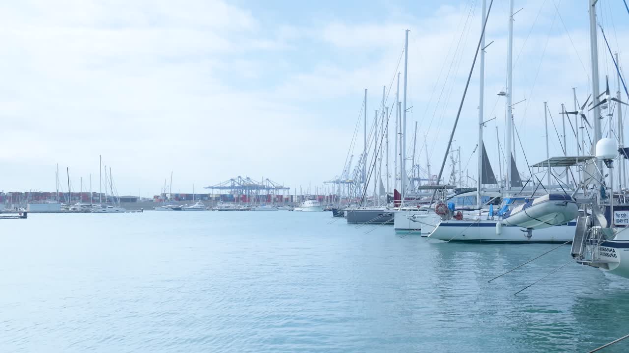 Boats in Marina at a Port with Container Ships in the Background