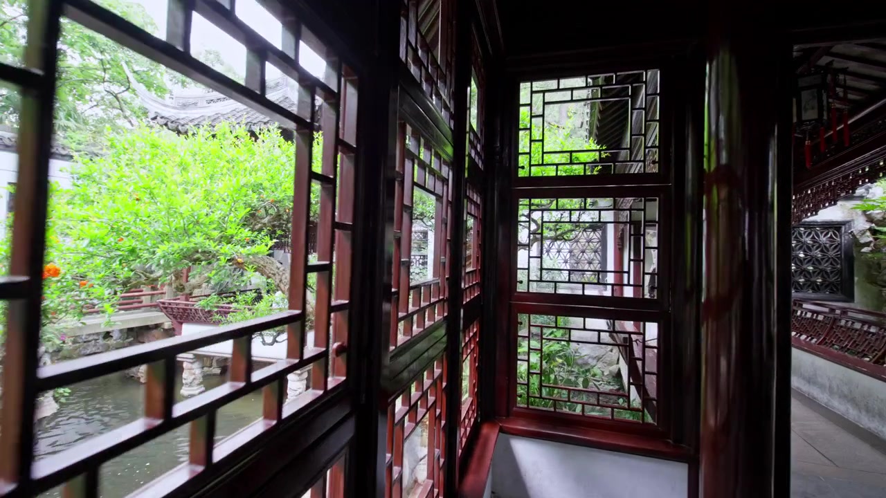 A narrow wooden corridor with intricate lattice windows offers a view of a lush garden. Sunlight filters through, creating a serene atmosphere. Ideal for cultural or architectural content.