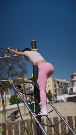 woman climbing a playground net