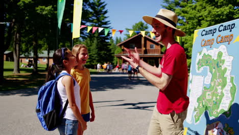 camp counselor welcoming children
